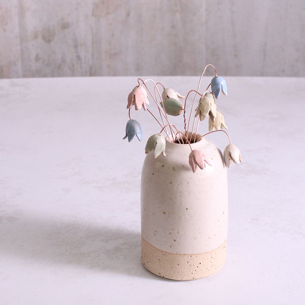 Pastel drop flower stems displayed in a handcrafted off-white speckled vase – artisan home décor by Habulous.