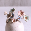 Pastel ceramic flower stems displayed in a handcrafted  ceramic vase – artisan home décor by Habulous