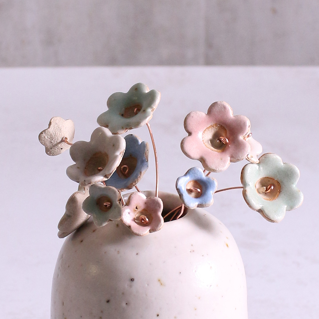 Pastel ceramic flower stems displayed in a handcrafted  ceramic vase – artisan home décor by Habulous
