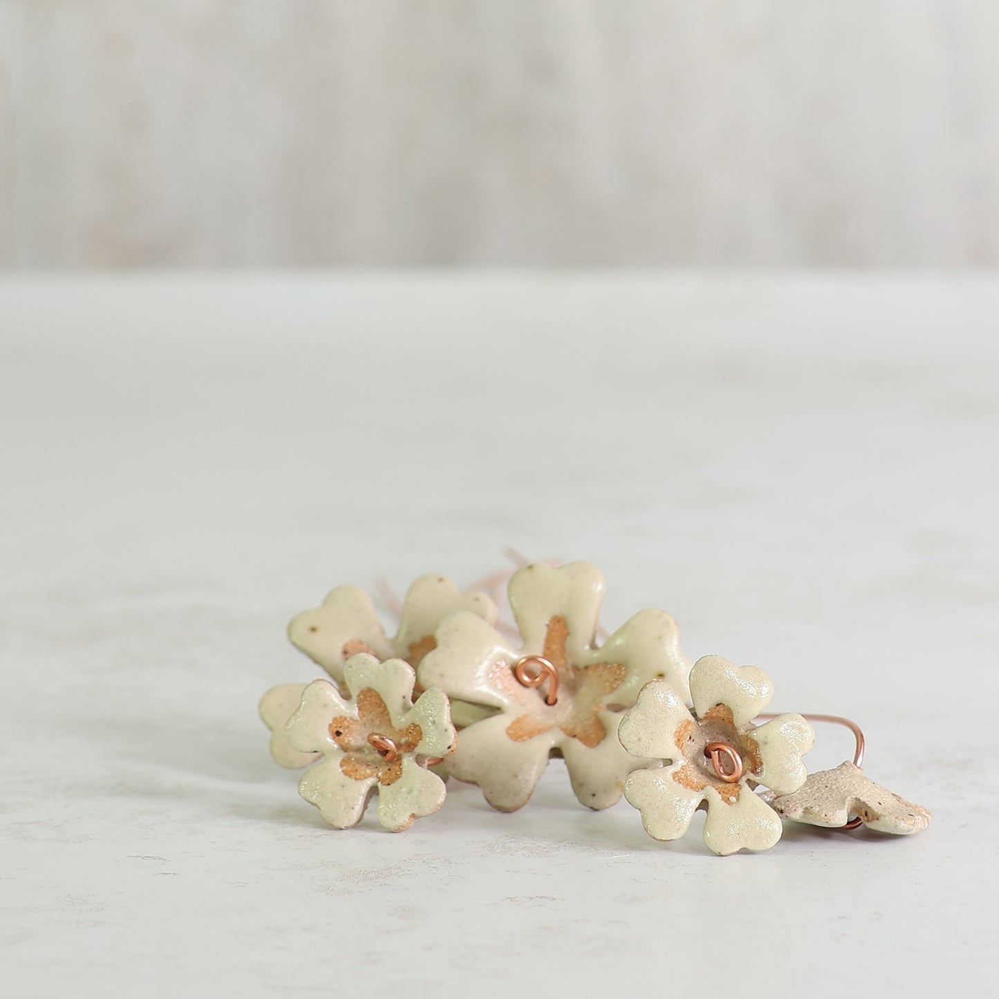Floral ceramic flowers laying on a light gray background