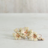 Floral ceramic flowers laying on a light gray background