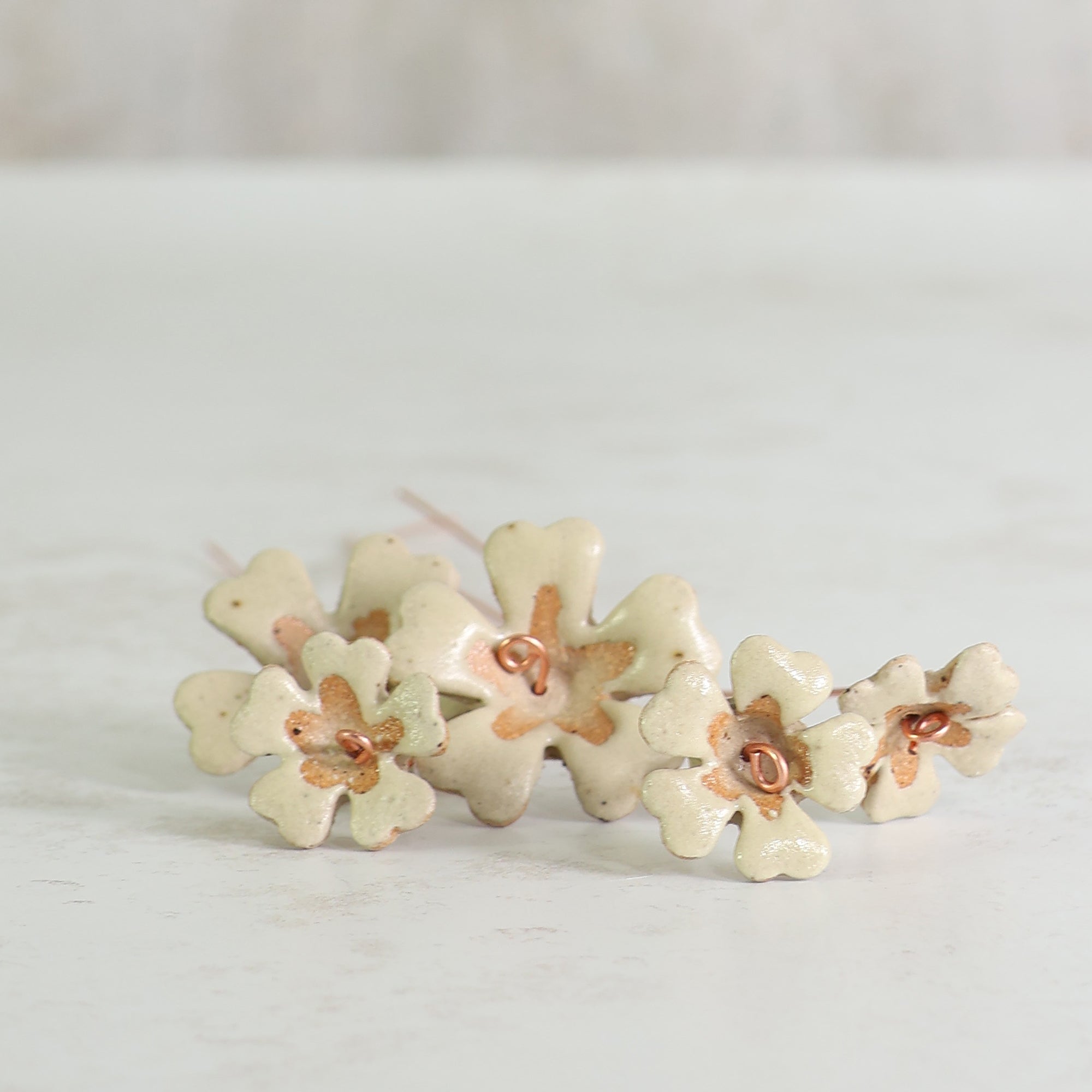 Primrose pale yellow ceramic flower stems on a light background