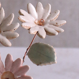Close-up of pastel ceramic flower stems with a ceramic leaf attached, they're on copper wire stems – individually handcrafted floral home accessories from Habulous