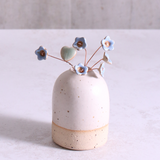 Pastel blue ceramic forget me not flower stems displayed in a handcrafted speckled vase – artisan home décor by Habulous