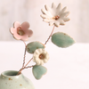 Close-up of pastel ceramic flower stems with ceramic leaves attached, they're on copper wire stems – individually handcrafted floral home accessories from Habulous