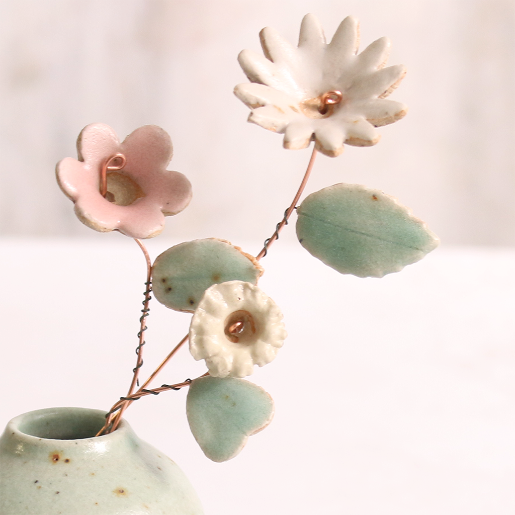 Close-up of pastel ceramic flower stems with ceramic leaves attached, they're on copper wire stems – individually handcrafted floral home accessories from Habulous