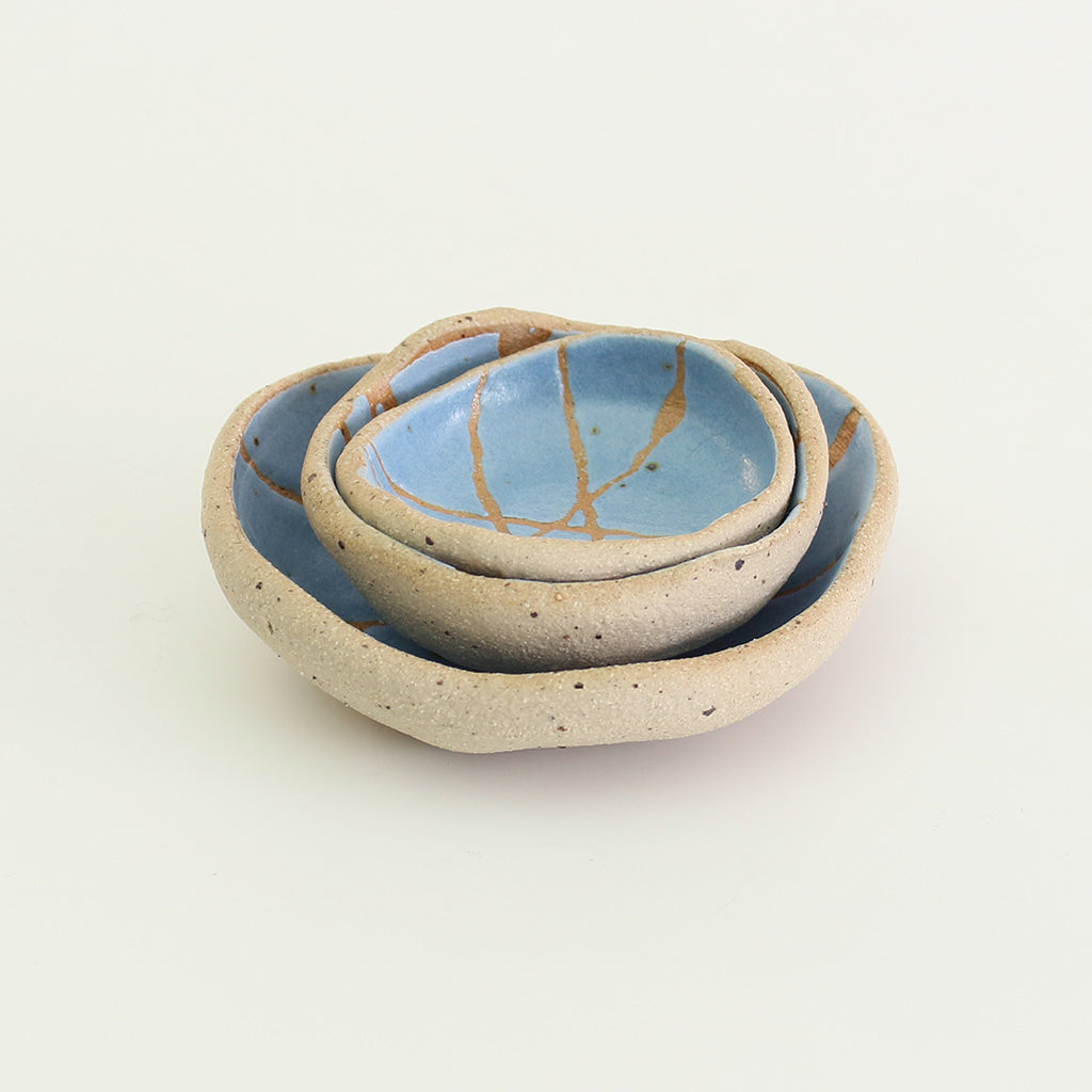 Mini and small patterned cornflower blue wonky bowls stacked inside medium wonky bowl