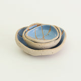 Mini and small patterned cornflower blue wonky bowls stacked inside medium wonky bowl