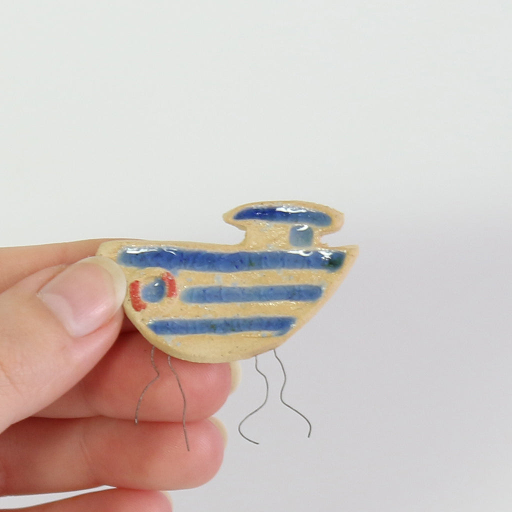 small ceramic and glass boat plant decoration
