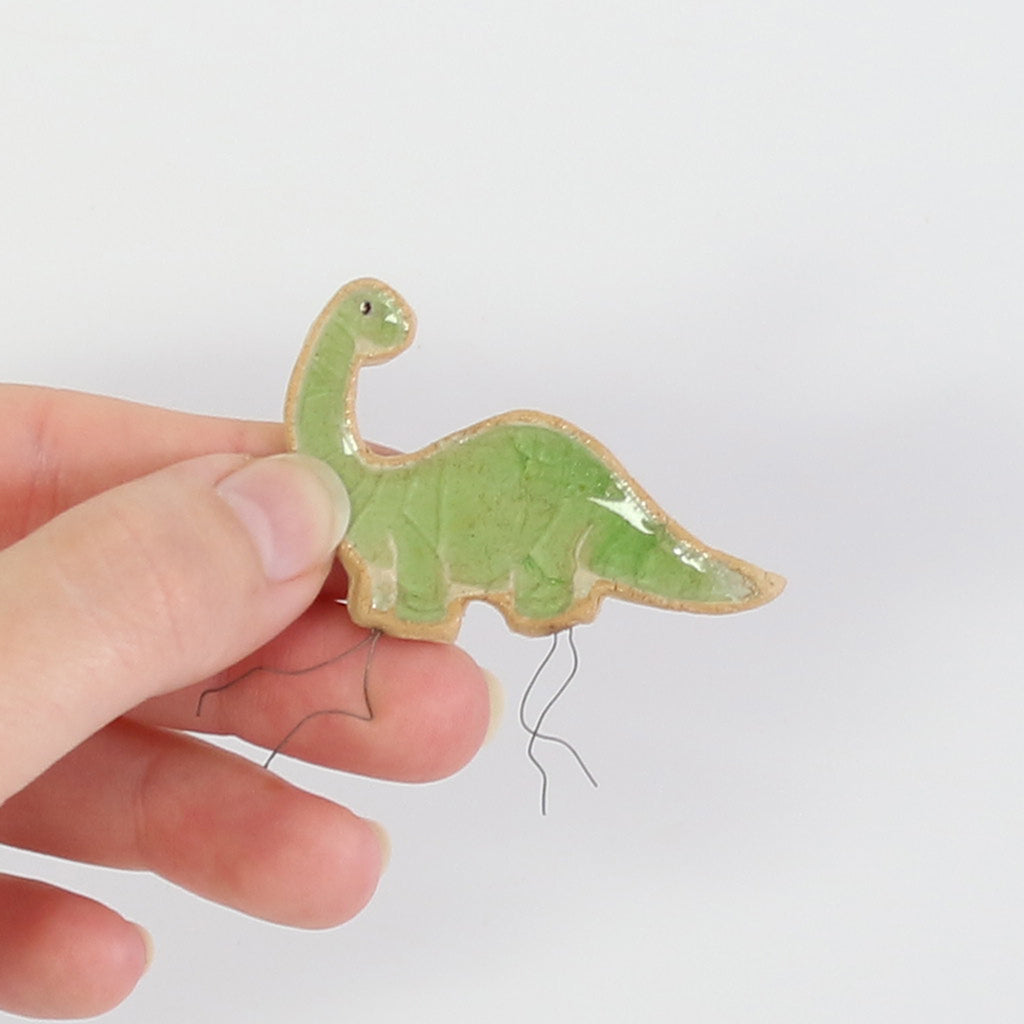 small ceramic and glass green brontosaurus dinosaur plant decoration