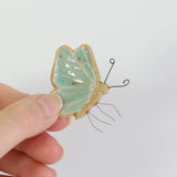 small ceramic and aqua blue glass butterfly plant decoration