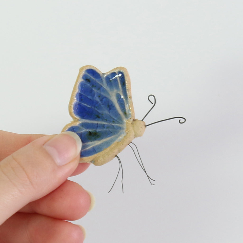 small ceramic and glass sapphire blue butterfly plant decoration