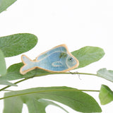 small ceramic and glass sapphire blue fish plant decoration, with thin wire wrapped around house plant stem