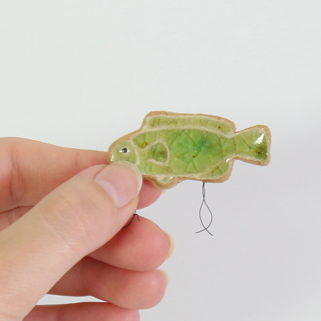 small ceramic and glass emerald green fish plant decoration