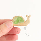 hand holding small snail plant hugger