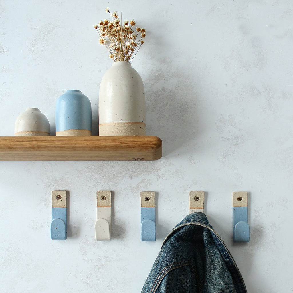 Alternating blue and white wall hooks with matching decor