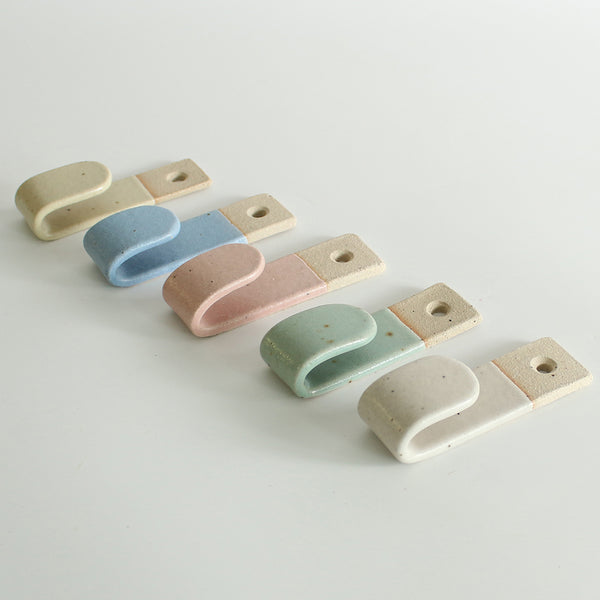 Side view of 5 pastel wall hooks