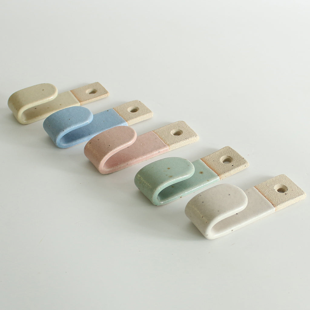 Side view of 5 pastel wall hooks