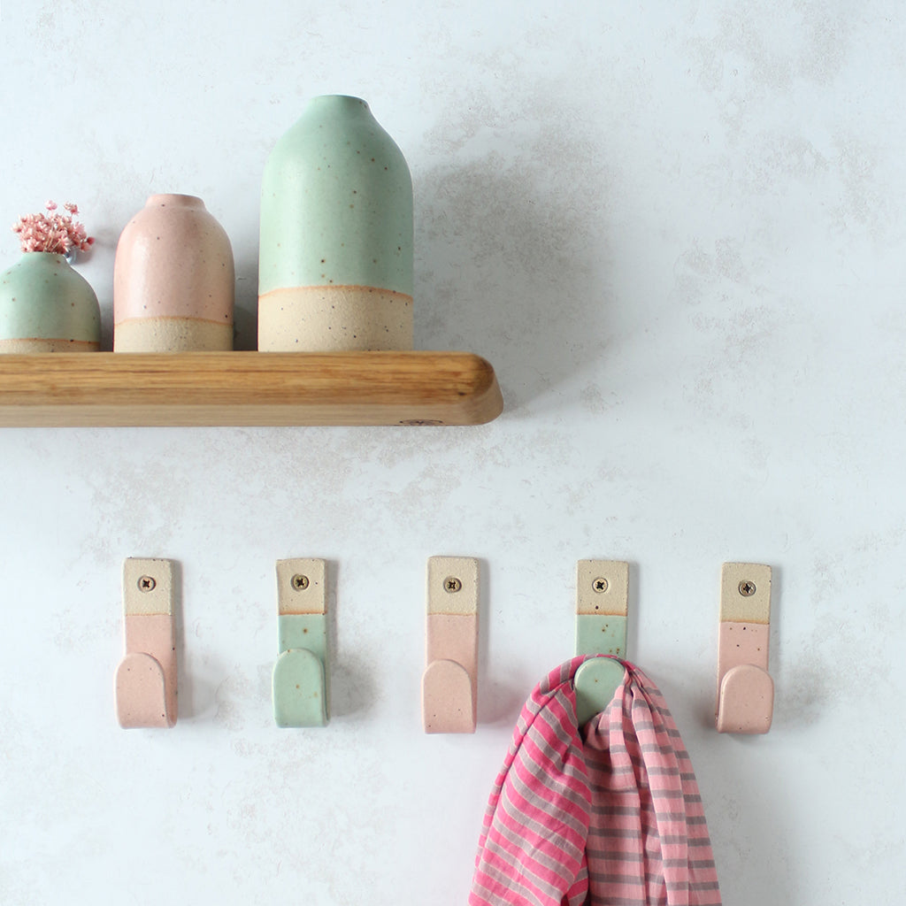 Alternating green and pink wall hooks with matching decor