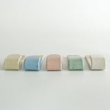 Underside view of five pastel wall hooks