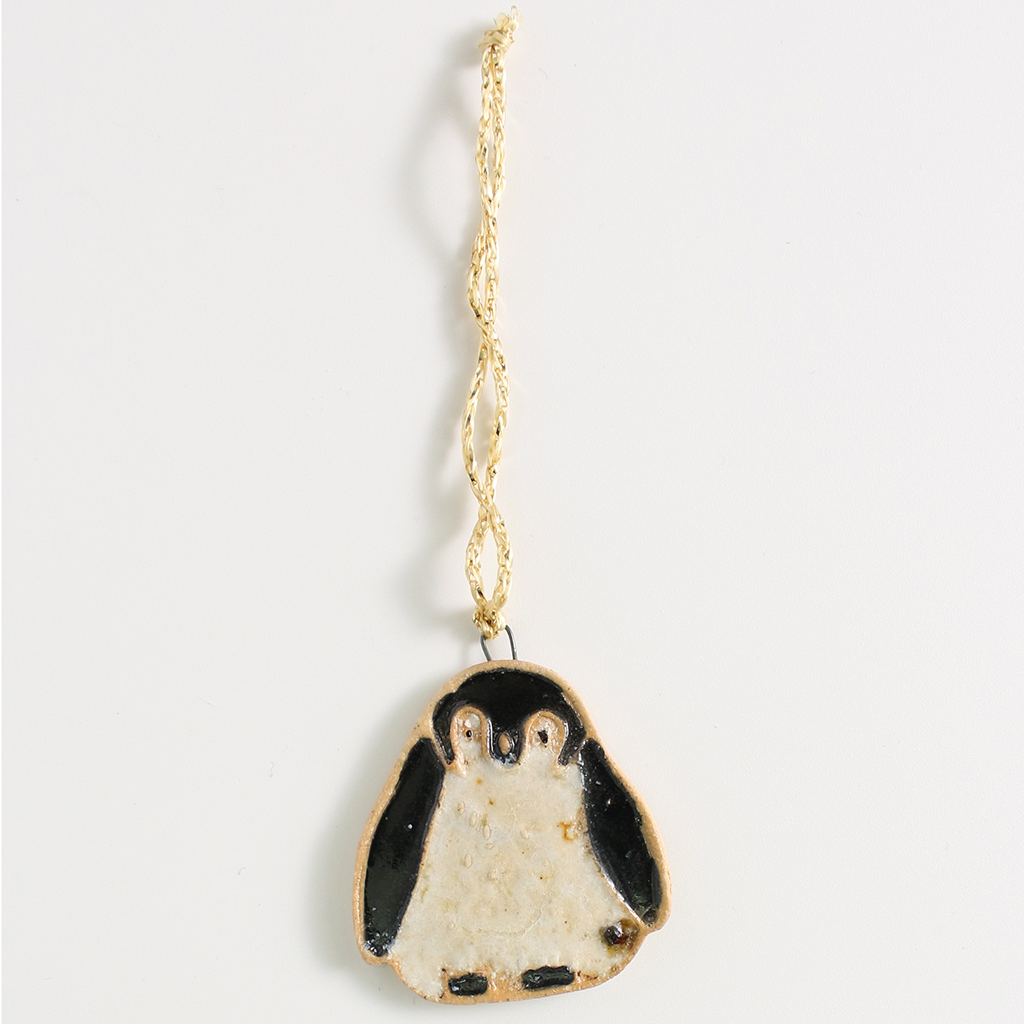 Christmas penguin decoration on a light gray background