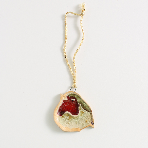 Ceramic robin Christmas decoration with a  gold string on a white background.