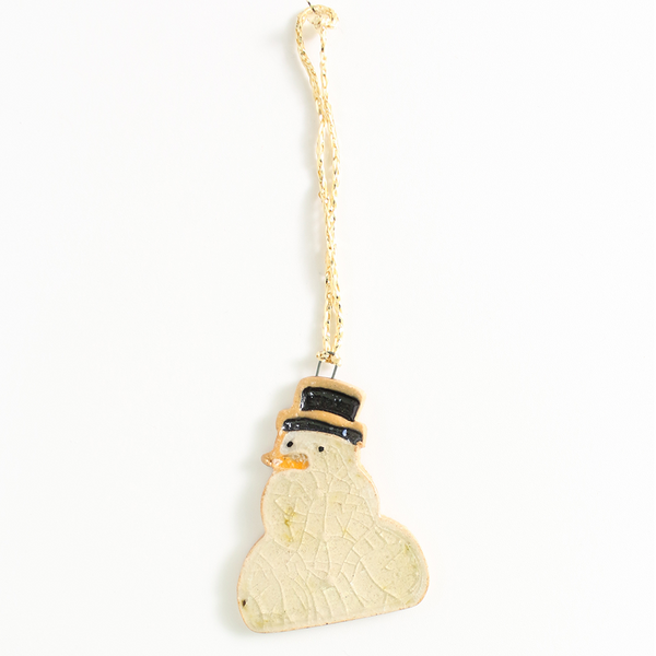 Christmas decoration shaped like a snowman with a gold string on a white background