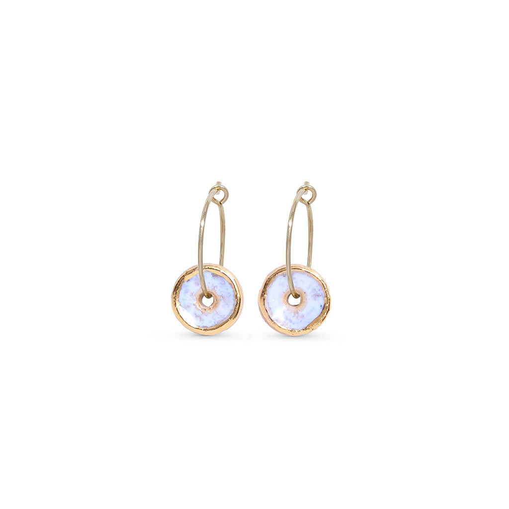 Pair of gold hoop earrings with light opal discs on a white background