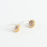 Pair of earrings with gold, pink and silver finishes on a white background