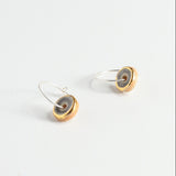 Pair of earrings with purple, gold and silver finishes on a white background