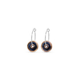 Pair of earrings with blue black circular designs with gold lustre outer on a white background