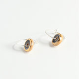 Pair of earrings with gold and black blue circular designs on a white background