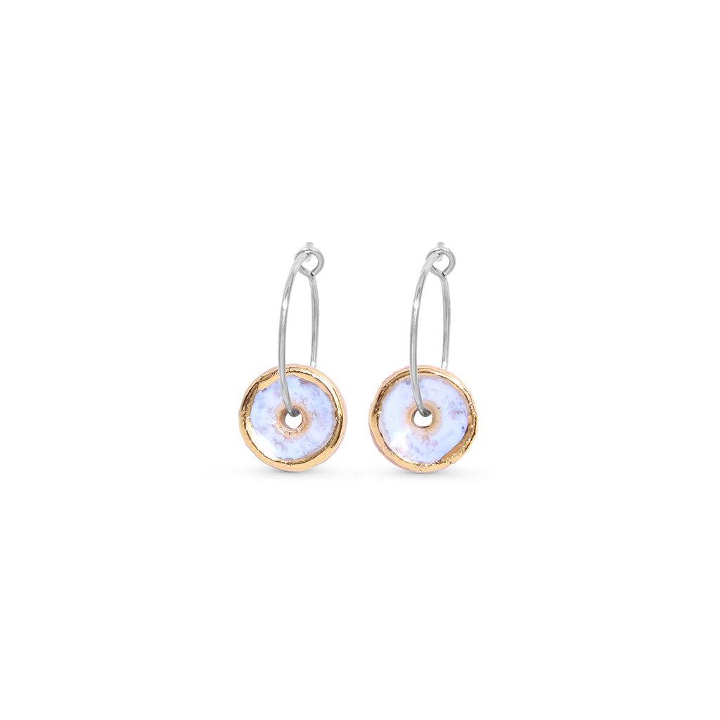 Pair of sterling silver earrings with circular designs on a white background