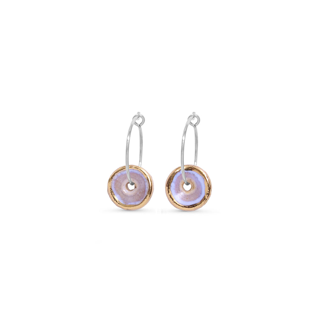 Pair of earrings with circular designs on a white background