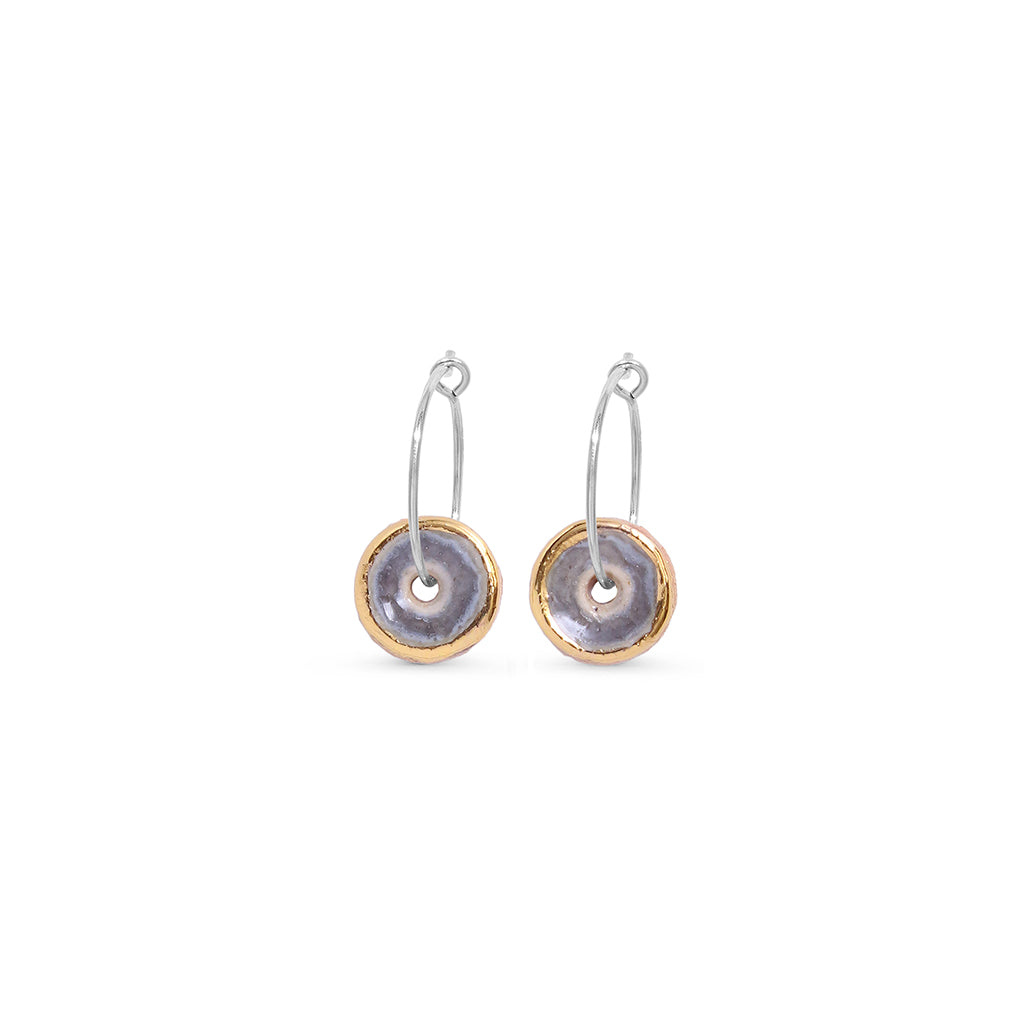 smoky purple sterling silver hoop earrings with a gold rim on a white background