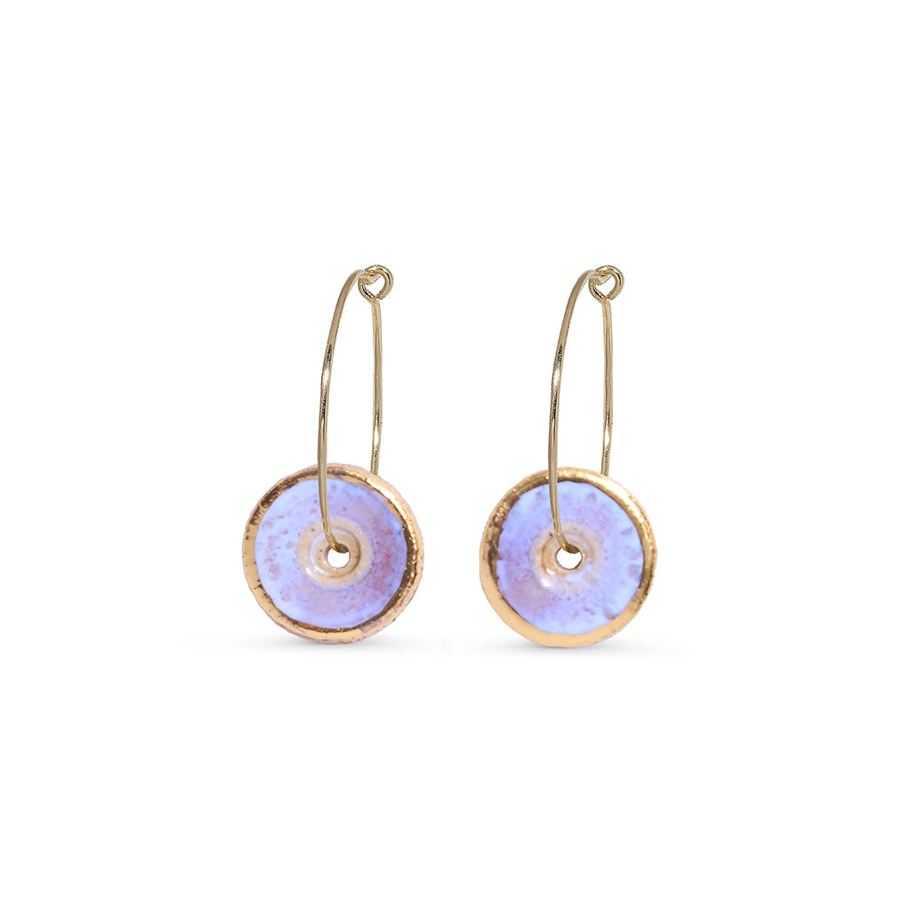 Pair of gold hoop earrings with opal circular discs on a white background