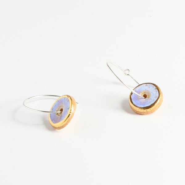 Pair of hoop earrings with round opal and gold disc charms on a white background