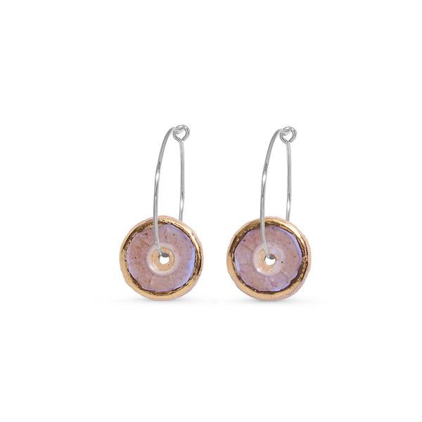 Pair of round earrings with gold, pink and silver accents on a white background