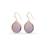 Gold-framed purple stone earrings on a white background