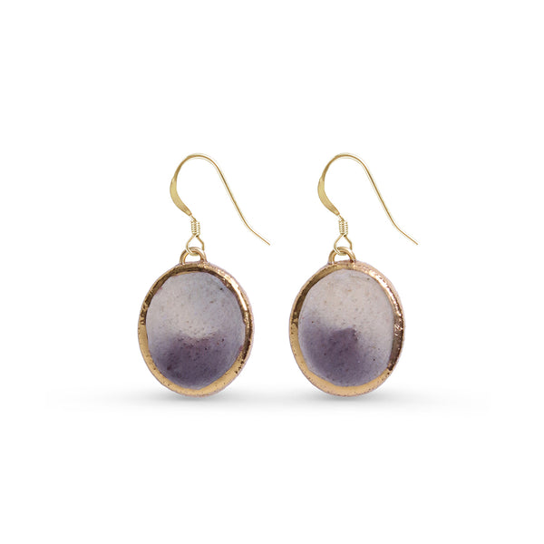 Gold-framed purple pendant earrings on a white background
