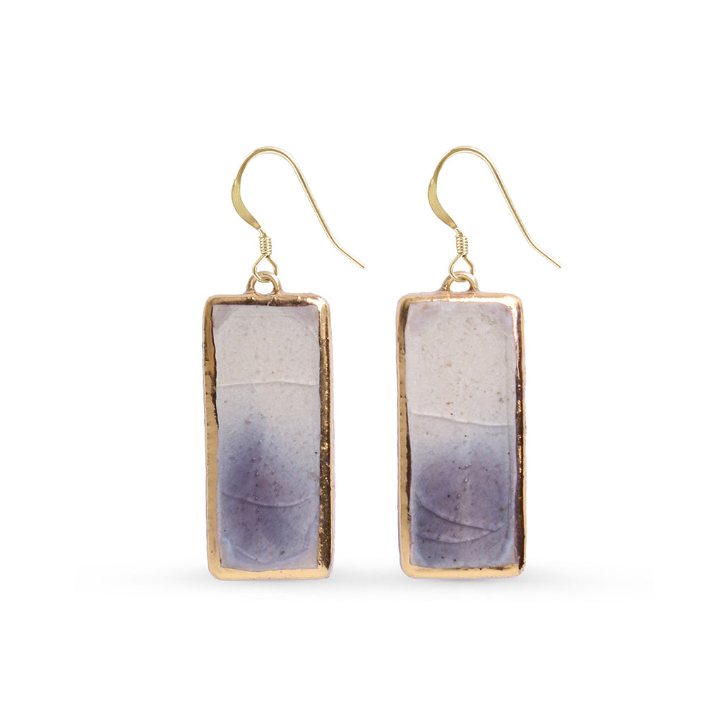 Pair of earrings with rectangular purple and gold design on a white background