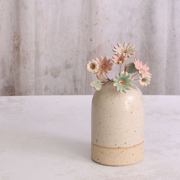 Handcrafted ceramic flower bouquet in a vase, featuring delicate pink and white wildflowers with green leaves, arranged with copper wire stems — perfect for rustic home decor.