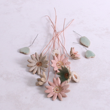 Handcrafted ceramic flower bouquet, featuring delicate pink and white wildflowers with green leaves, arranged with copper wire stems — perfect for rustic home decor.