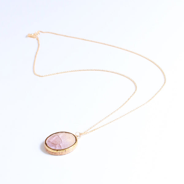 Necklace with a pink pendant on a white background