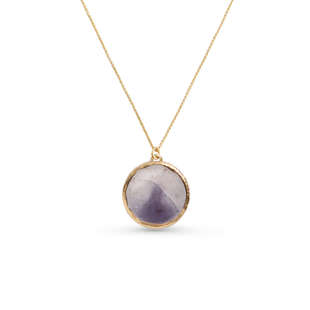 Necklace with a round purple pendant on a gold chain against a white background