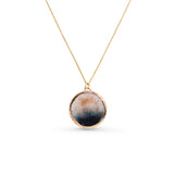 Gold Necklace with a round pendant on a white background