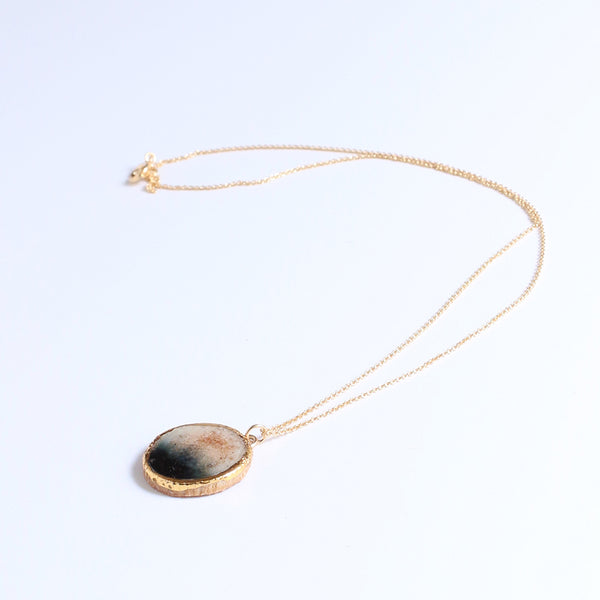 Necklace with a round pendant on a white background