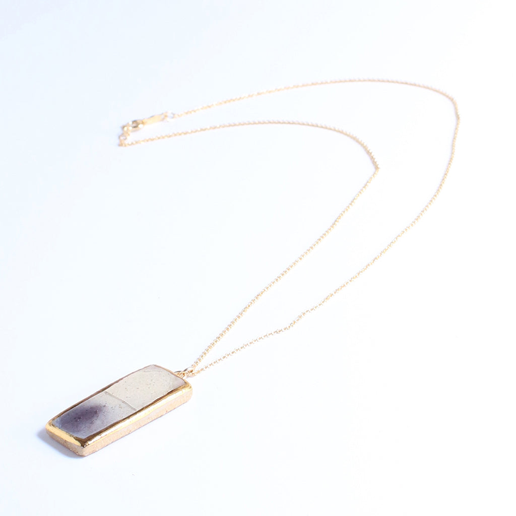Necklace with a rectangular pendant on a white background