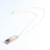Necklace with a rectangular pendant on a white background