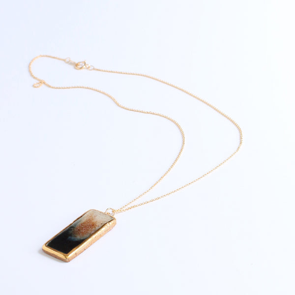 Necklace with a rectangular pendant on a white background